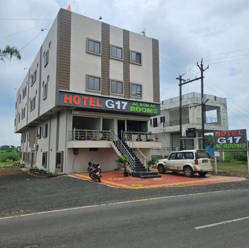 a hotel building with a motorcycle parked in front of it at Hotel G17 and Restaurant in Dhāmnod