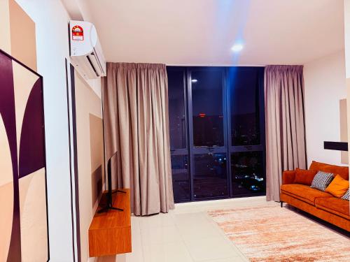 a living room with a couch and a large window at Majestic Residence Klcc in Kuala Lumpur
