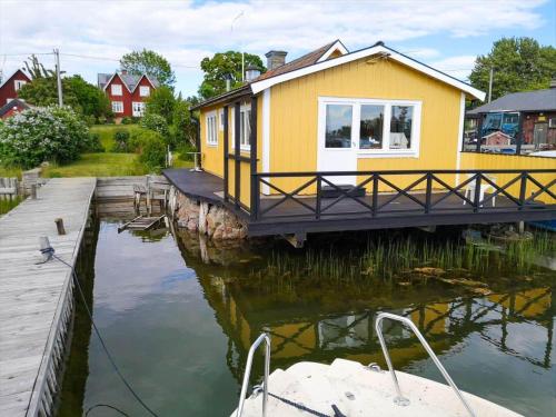 a house on a dock next to a body of water at STO717-Blidoe-Nedre-Byvaegen-56 in Finnholmen