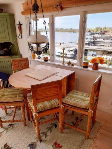 a table and chairs in a kitchen with a window at STO717-Blidoe-Nedre-Byvaegen-56 in Finnholmen