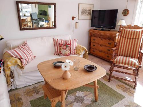 a living room with a white couch and a table at STO717-Blidoe-Nedre-Byvaegen-56 in Finnholmen
