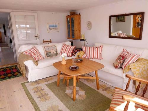 a living room with a white couch and a table at STO717-Blidoe-Nedre-Byvaegen-56 in Finnholmen
