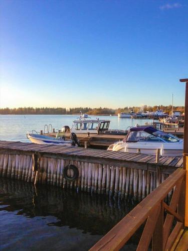 a group of boats docked at a dock on the water at STO717-Blidoe-Nedre-Byvaegen-56 in Finnholmen