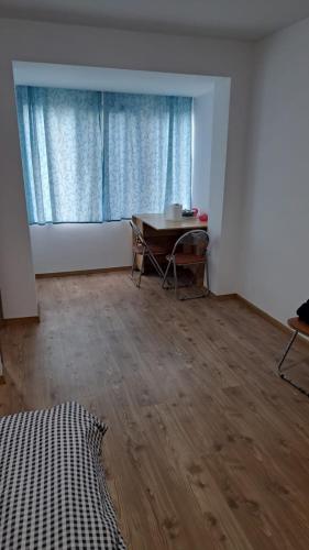 an empty room with a table and a window at Geoagiu-Bai central studio in Geoagiu Băi