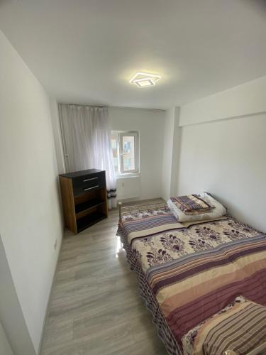 a bedroom with two beds and a dresser at Ploiesti-Republicii RH in Ploieşti