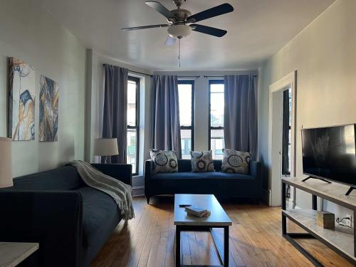 a living room with a blue couch and a tv at South Loop 3 Bedroom Apt in Chicago