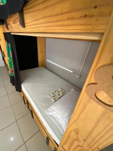 a small bed in a wooden bunk bed at Arwanã Beach - Pousada e Hostel in Fortaleza