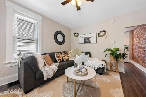 a living room with a couch and a table at Sophisticated Boho Condo Walkable Columbus in Columbus