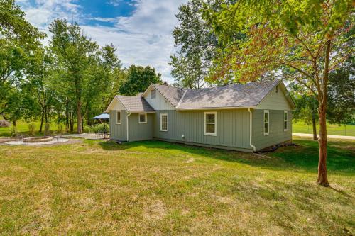 a small green house with a yard at 5 Mi to Kansas Speedway! Cowtown Cutie KC in Kansas City