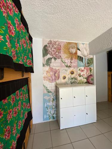 a room with a flower mural on the wall at Arwanã Beach - Pousada e Hostel in Fortaleza