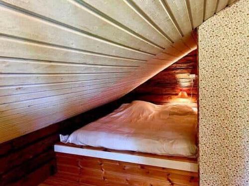 a bed in a wooden room with at KRO589-Moheda-Groenaberg-5 in Förhult