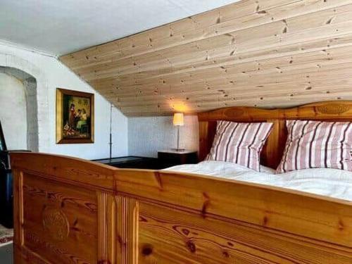a large wooden bed in a room at KRO589-Moheda-Groenaberg-5 in Förhult