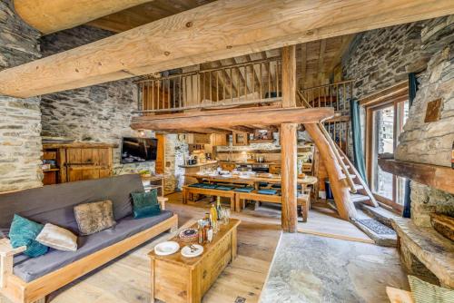 a living room with a couch and a staircase at Chalet Lo Soli - Chalet au charme rustique pour 12 personnes MAE-6974 in Tignes