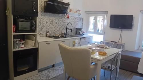 a kitchen with a table and a stove top oven at Casa Riad in Lesmo