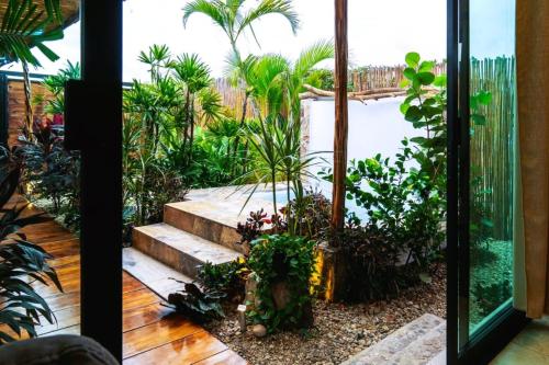 a garden with a pool and some plants at Loft Suite Altitude Cabin in Bajos de Chila
