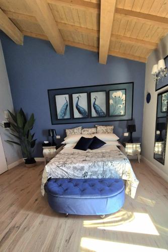 a bedroom with a large bed with blue walls at Dream Apartments alloggio turistico in Civitavecchia