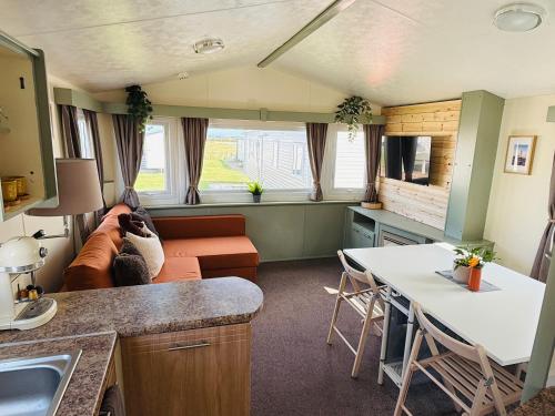 a living room with a couch and a table at 'Olive' by the Sea in Whitley Bay