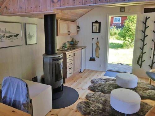 a kitchen with a stove in the middle of a room at ORE742-Granbergsdal-Dalsmund-Arvidsudden-780 in Lersjötorp