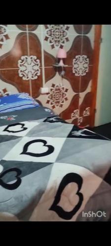 a poster of a bedroom with a bed with numbers on it at Hotel Hospedaje Iquique in Iquique