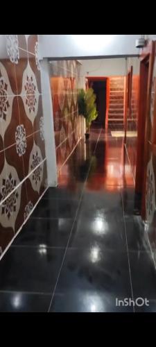 a hallway with a tile floor with a plant in it at Hotel Hospedaje Iquique in Iquique