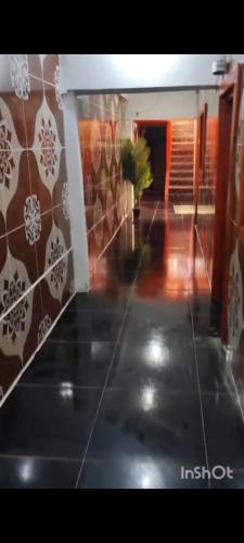 a room with a tile floor and a hallway at Hotel Hospedaje Iquique in Iquique