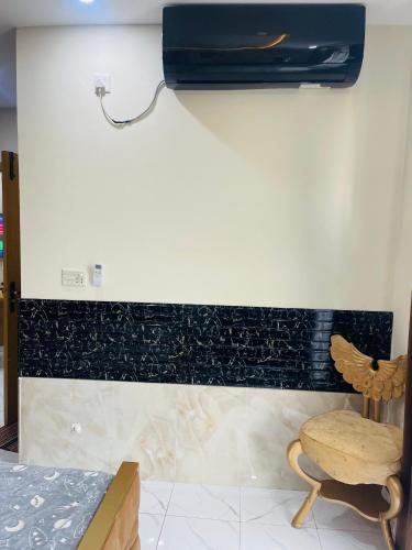 a room with a wall decorated with black and white tile at 1 Bedroom Apartment in Gulberg Green in Islamabad