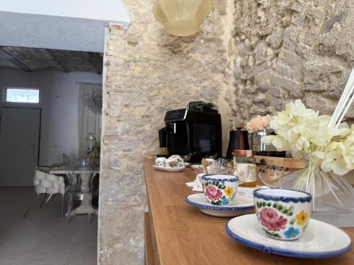 a table with cups and plates on top of it at La Presentosa b&b in Fossacesia