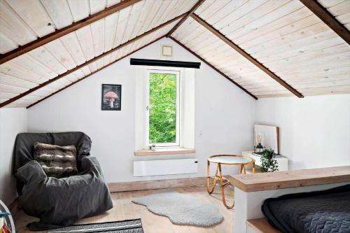 a room with a bed and a chair and a window at SKA615-Tormestorp-Bjoerkhaellsbacken-7 in Tormestorp