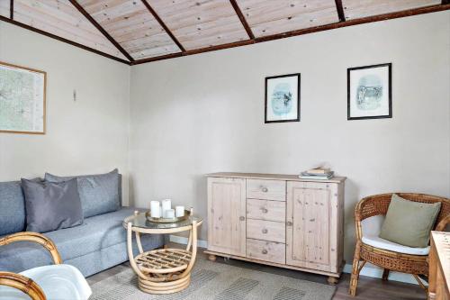a living room with a couch and a table and chairs at SKA615-Tormestorp-Bjoerkhaellsbacken-7 in Tormestorp