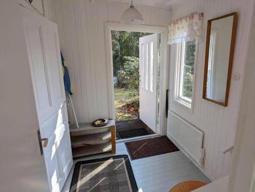 a hallway of a tiny house with an open door at KAL672-Langasjoe-Trollamala-215 in Långasjö