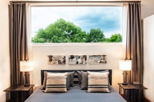a bedroom with a large window above a bed at Heart of Vibrant Railyard-Large Downtown Loft with Prime Location and Beautiful Deck in Santa Fe
