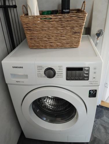 a washing machine with a basket on top of it at Modern cottage, quiet area with good bus connection in Luleå