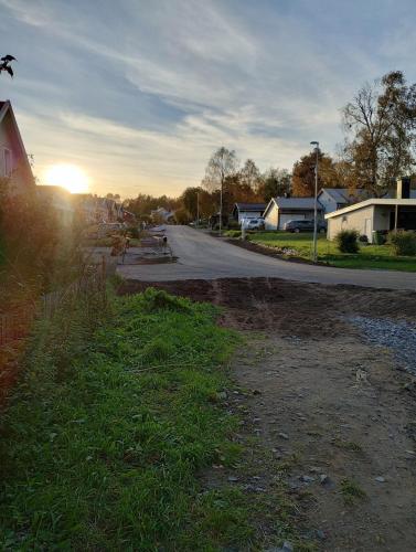an empty street in a residential neighborhood with the sunset at Modern cottage, quiet area with good bus connection in Luleå