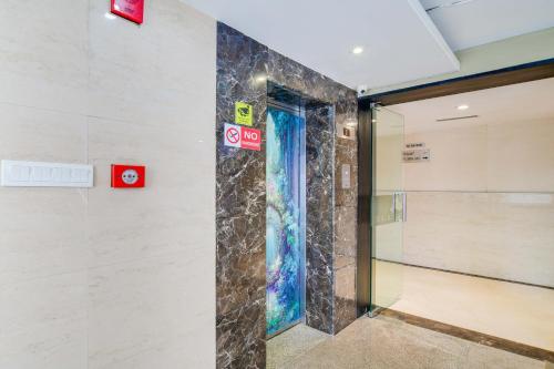 a glass door in a wall with signs on it at Palette Sapphire Star Chappan Market in Indore