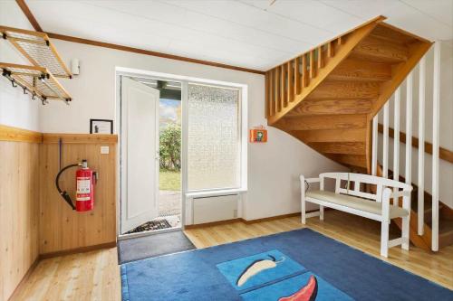 a room with a blue rug and a staircase at KAL535-Virserum-Askliden-11 in Virserum