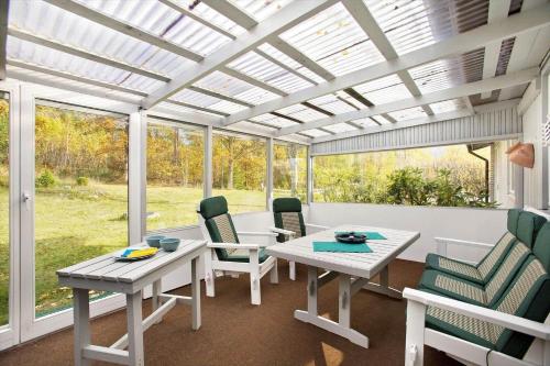 a dining room with a pergola and a table and chairs at KAL535-Virserum-Askliden-11 in Virserum