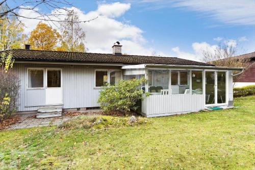 a small white house with a large yard at KAL535-Virserum-Askliden-11 in Virserum