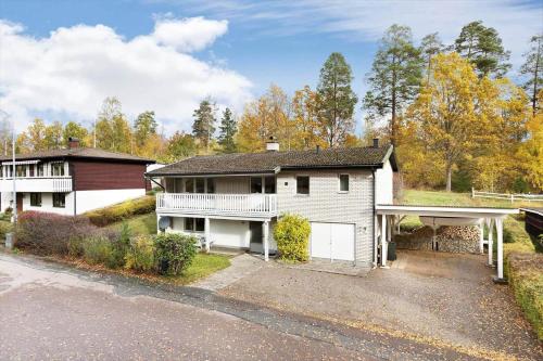 a white house with a porch and a garage at KAL535-Virserum-Askliden-11 in Virserum
