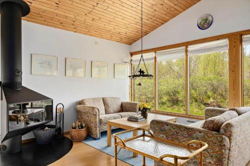a living room with two couches and a table at SKA627-Bastad-Tylevaegen-2 in Grevie