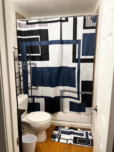 a bathroom with a toilet and a shower curtain at Renovated Downtown Phoenix Condo in Phoenix