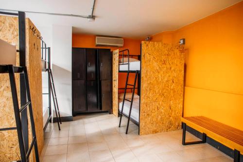 a room with two bunk beds and a bench at Socialtel Medellin in Medellín