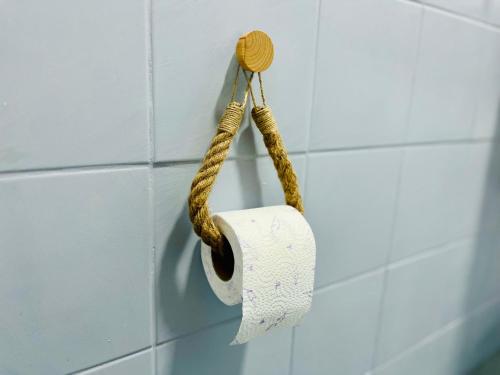 a roll of toilet paper hanging on a wall at Zayed Residence in Mostar