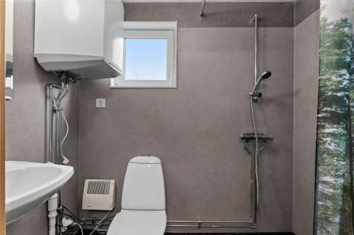 a bathroom with a shower and a toilet and a sink at BLE596-Soelvesborg-Aeskemovaegen-26 in Sandbäck
