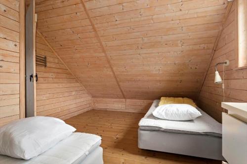 a sauna with two beds in a wooden room at BLE596-Soelvesborg-Aeskemovaegen-26 in Sandbäck
