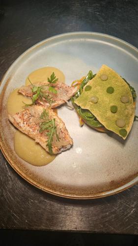 a plate of food with fish and a tortilla at Altes Pfarrhaus Hotel und Restaurant in Bad Überkingen