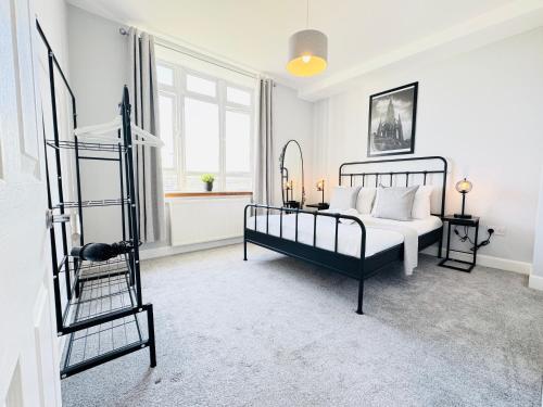 a bedroom with a bed and a ladder at Skyline View Apartment in Edinburgh