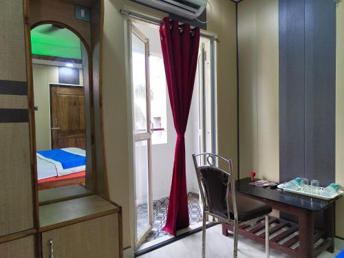 a room with a desk and a mirror and a bed at Hotel SVR Residency Sea View Puri - Known as Puri Inn - Near Light House Sea Beach - Swargadwar Golden Beach -Bengali Market- Lift - Parking - Best Premium Hotel in Puri in Puri
