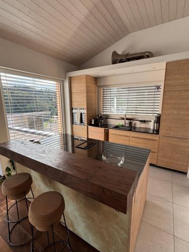 a kitchen with a large wooden island in a room at Boutique Penthouse Terrace Apartment in JuraParc in Wil