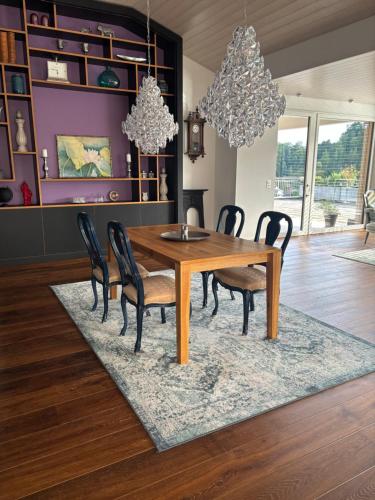 a dining room with a wooden table and chairs at Boutique Penthouse Terrace Apartment in JuraParc in Wil
