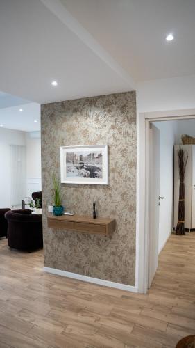 a living room with a wall with a shelf on it at Conte Durini Apartments & Rooms in Arcore